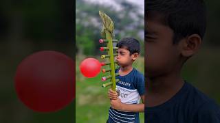 A big toy made with a palm tree branch and balloons #diy #art